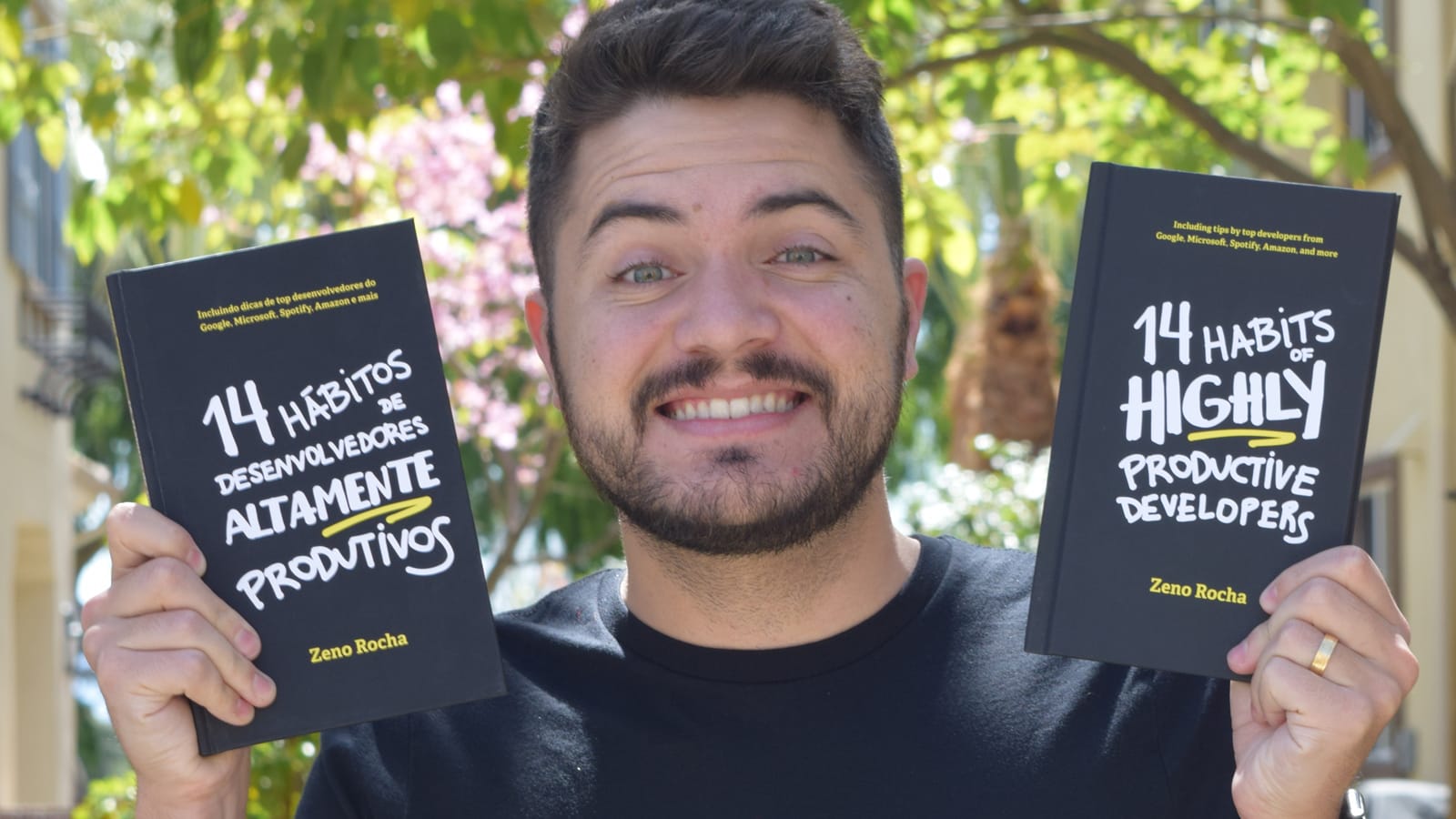 Zeno Rocha holds the physical editions of the book, respectively, in Portuguese and English